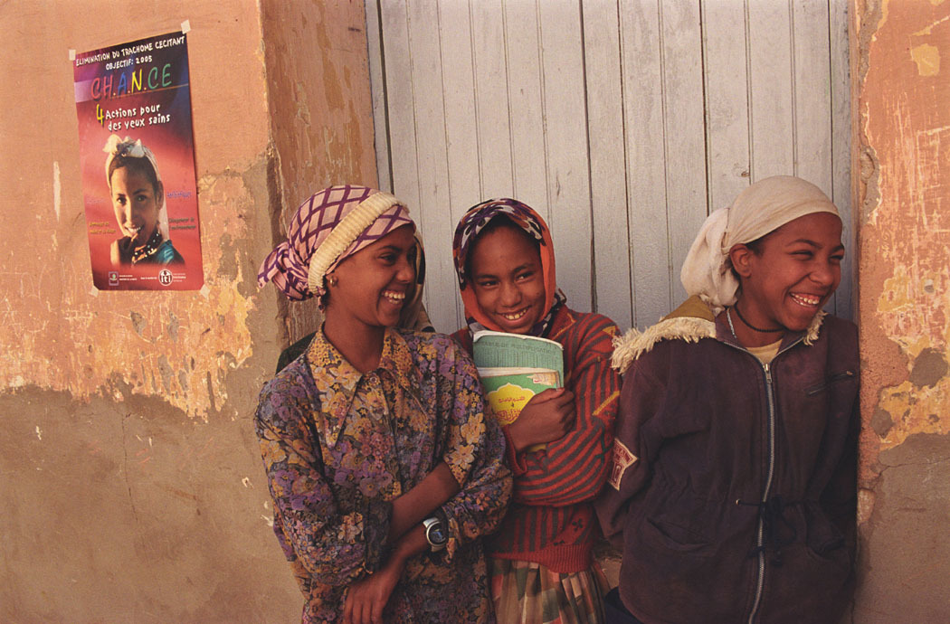 A group of girls laughing in a doorway